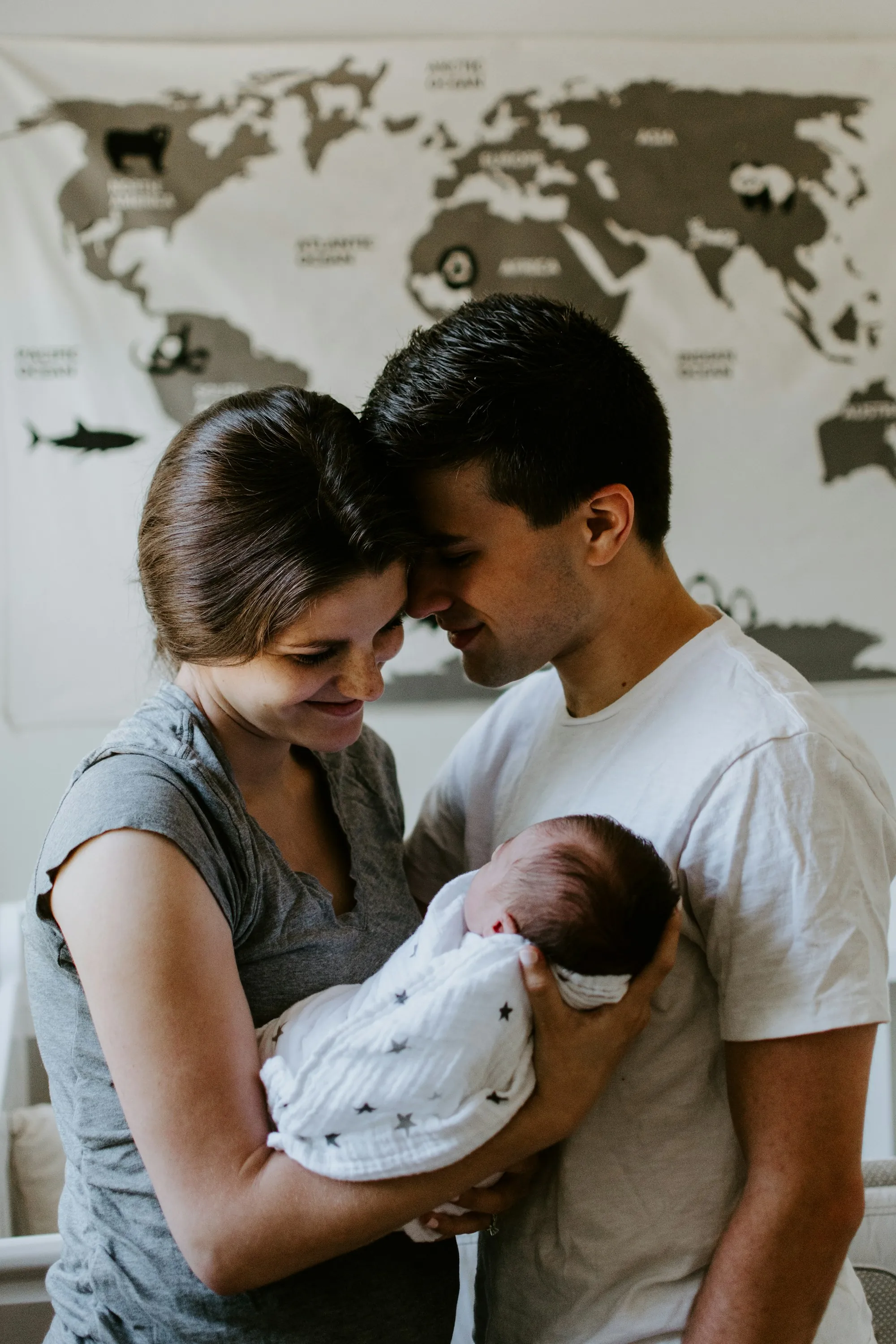 Mother and father holding their newborn together