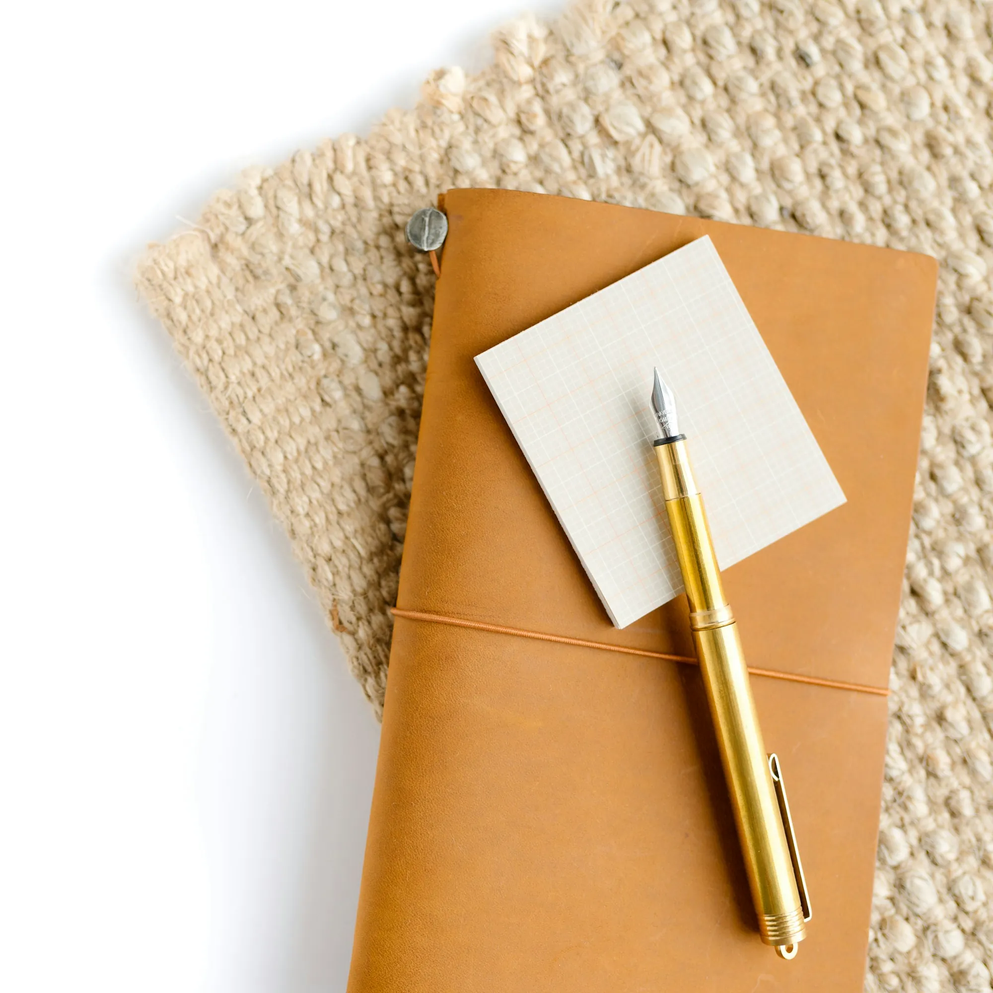 Leather notebook and fountain pen on a woven mat, for noting a term life conversion deadline in Deerfield