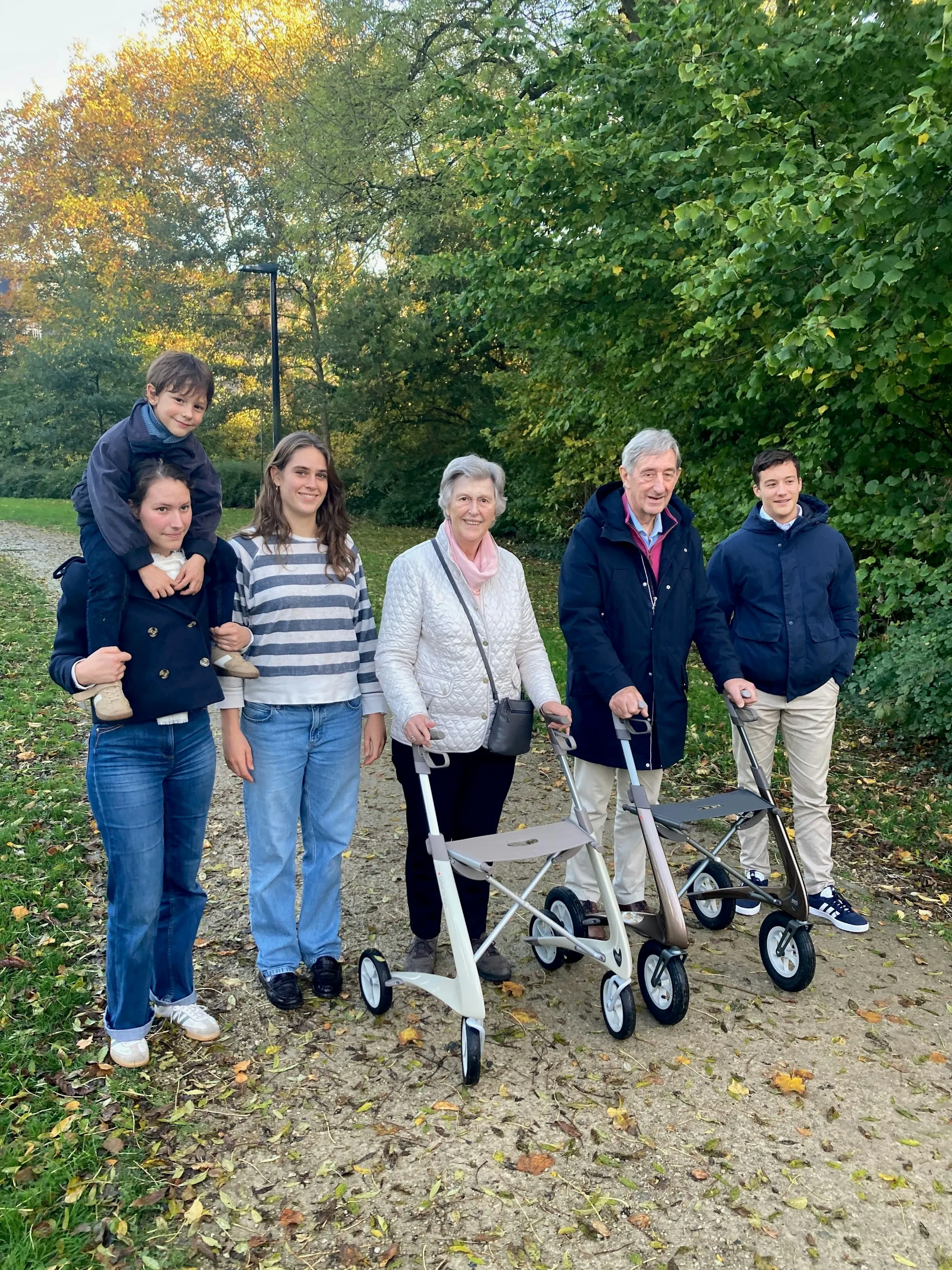 Three generations of a family walking together in a park